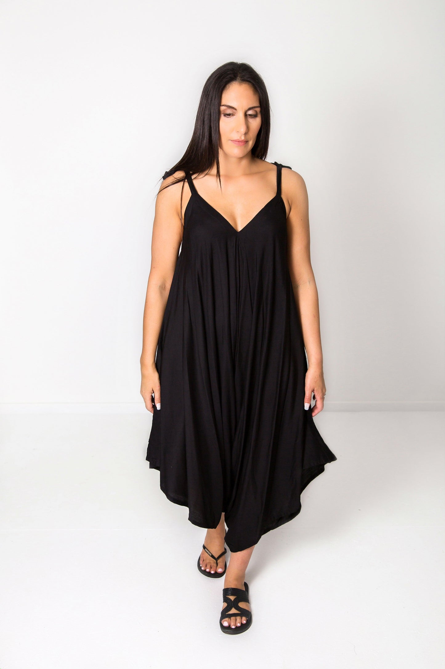 Photo of model wearing NOOZ Bali Jumpsuit, unbelted, in black.